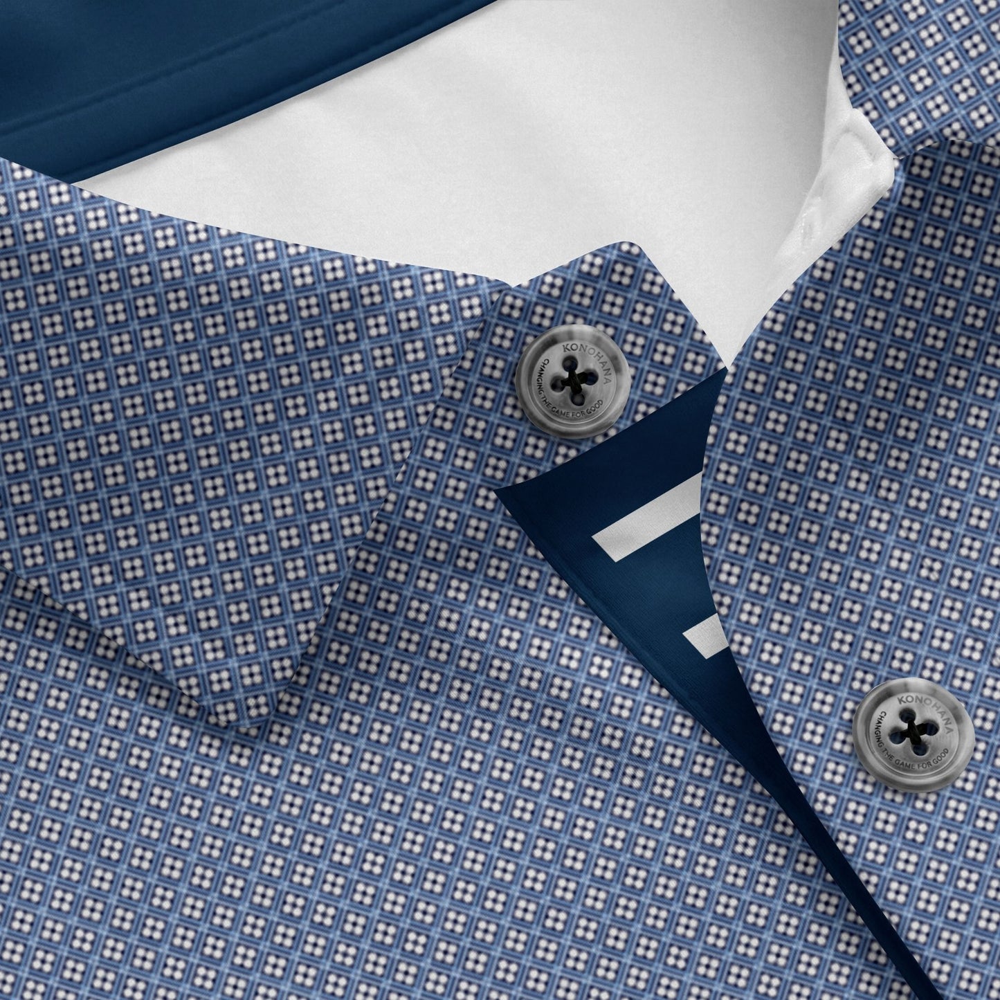 Close-up of a blue patterned shirt with a button and collar detail.